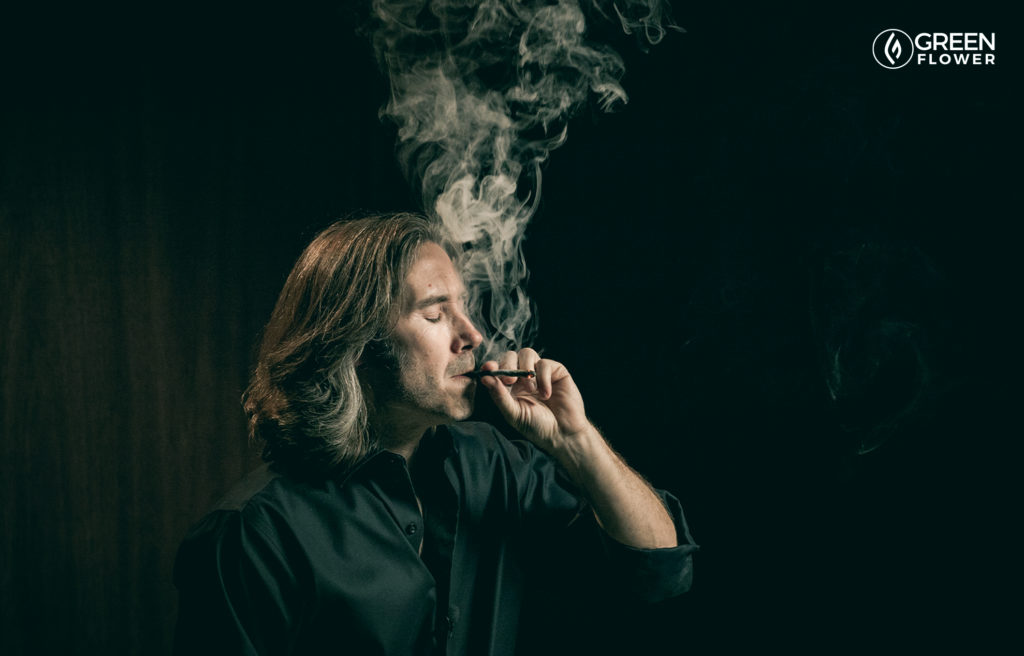 man smoking joint in black shirt